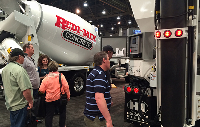 Attendees at World of Concrete scope out the Beck Industrial 10.5 half yard paver mixer with a Freightliner 114SD set back axle.