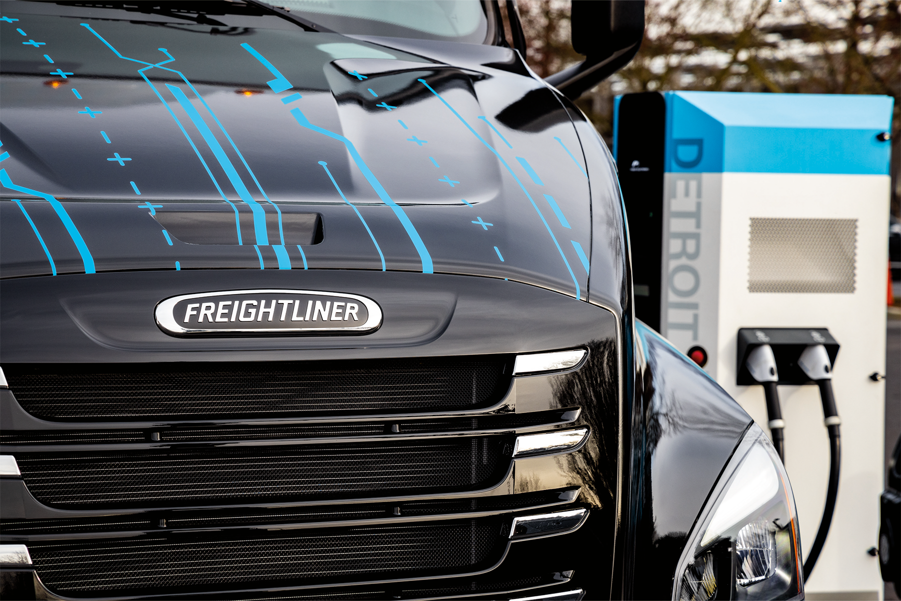 Electric trucks charging at a charging depot